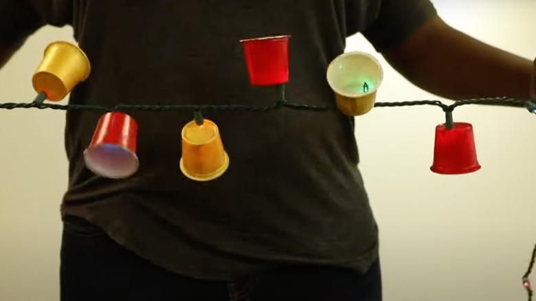 man holding k-cup party lights