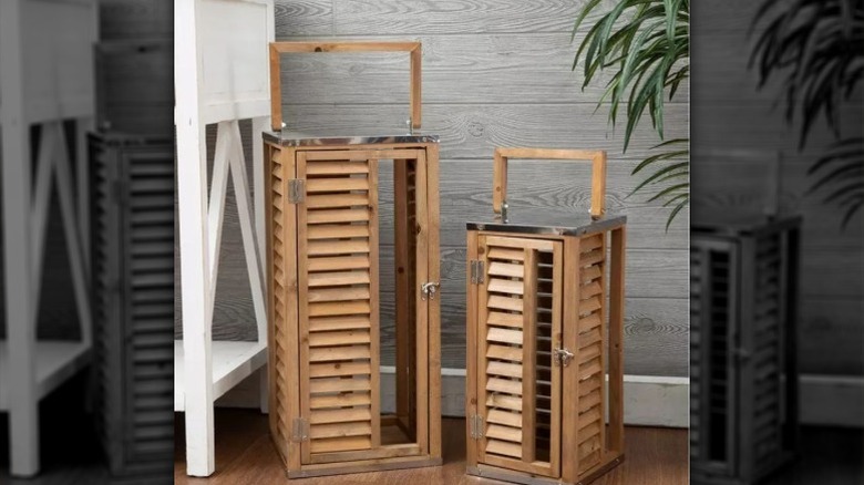 Two wooden lanterns with shutter slats.