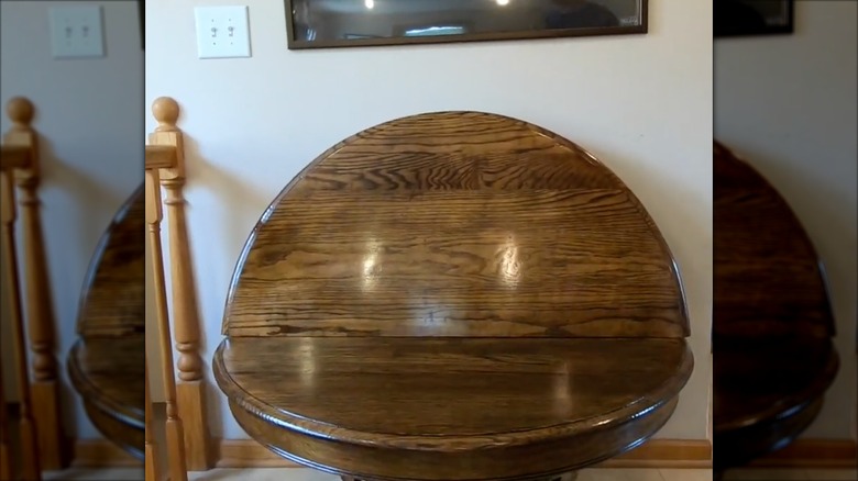 Round dining table converted into a seating bench in a home