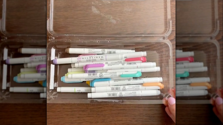 markers in plastic berry container