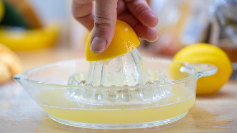 Hand juicing a lemon