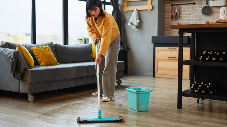 person mopping hardwood