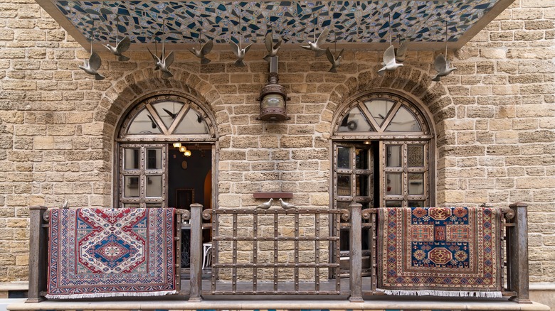 Rugs tossed over railing