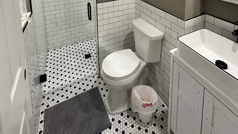 Black and white penny tiles on bathroom floor