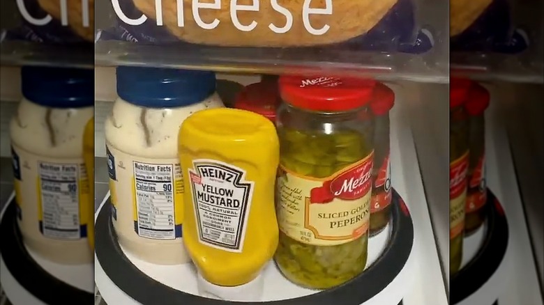 Condiments inside a refrigerator on a lazy Susan