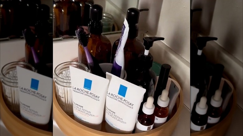 A variety of skin care in a bathroom on top of a lazy Susan