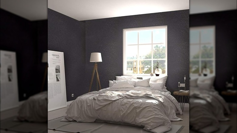 Textured black wallpaper in a chic white bedroom