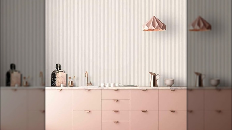 Low contrast striped wallpaper in a pink and neutral kitchenette