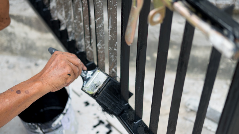 hand painting iron fence