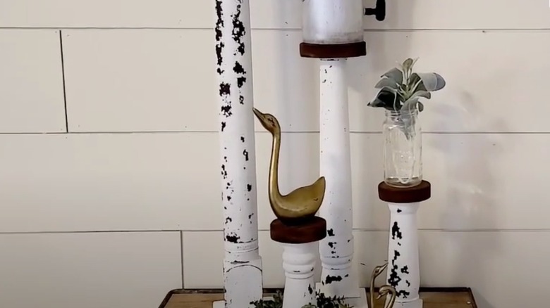 A few chair legs that have been painted white and turned into candle holders