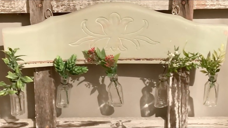 Headrest of a chair converted into flower display