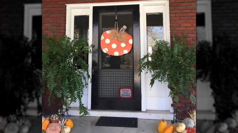 Front door with pumpkin decorations