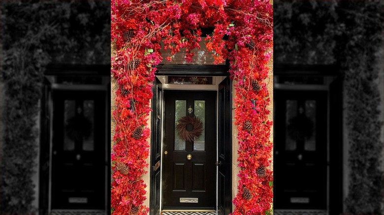 Black door with red floral décor