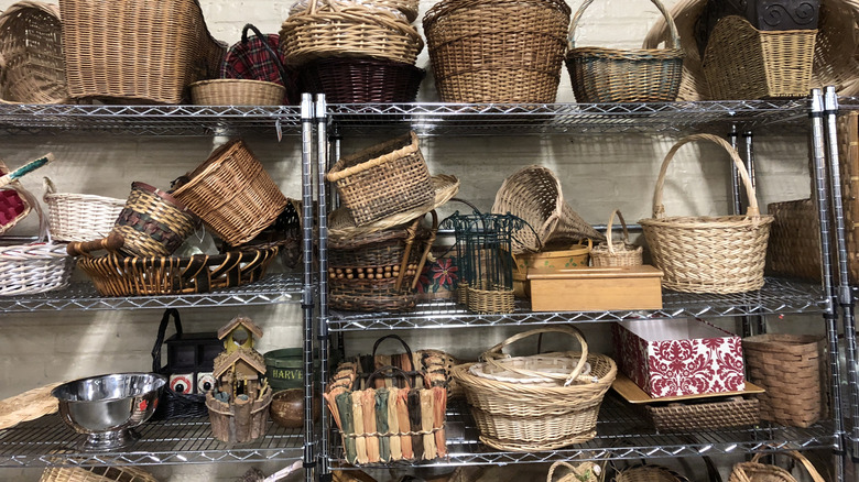 Metal shelves at a thrift store are well-stocked with a variety of baskets.