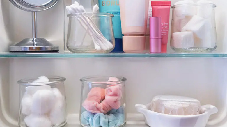 bathroom shelves with glass jar organizers