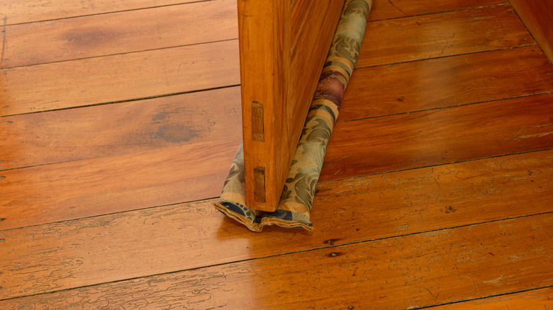 Door snake under wood door