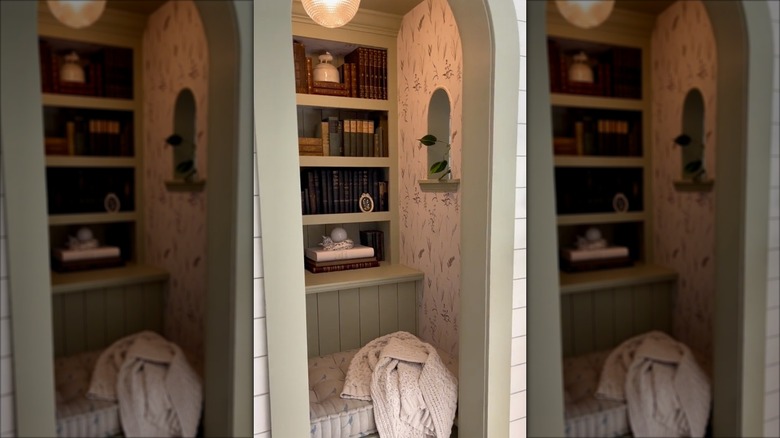 Closet turned into a reading nook with bench and shelves of books