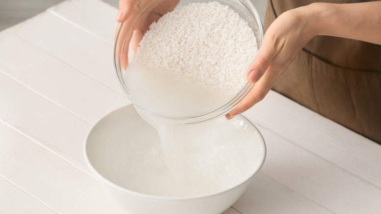 Pouring rice water into bowl