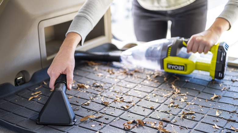 Hand vacuuming leaves