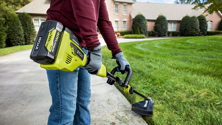 Man using landscaping trimmer