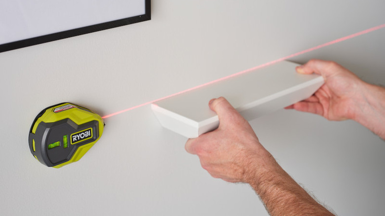 Hanging shelf with laser level