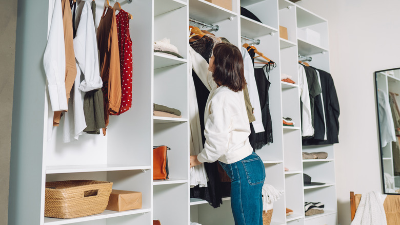 woman organizing items in closet