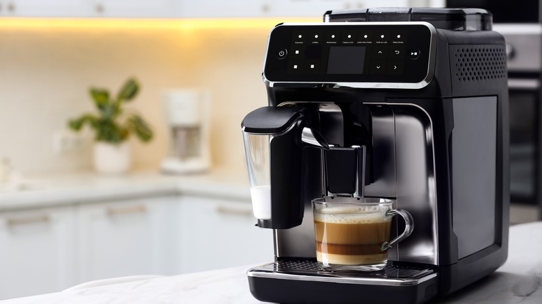 Coffee maker pouring coffee