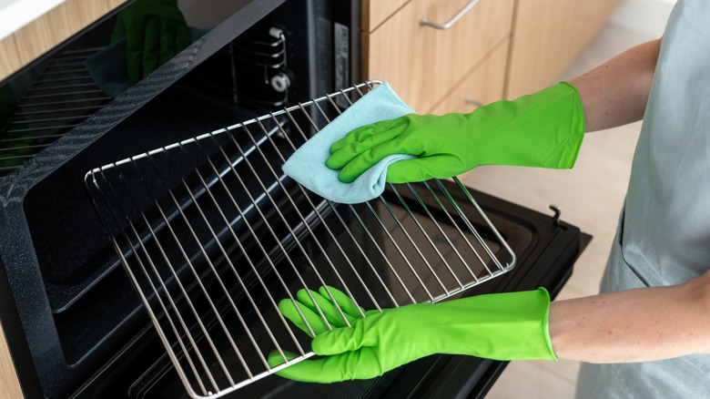 Hands cleaning oven rack