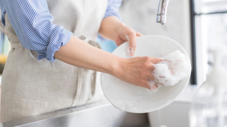 Washing dishes with soap