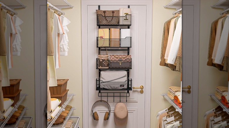 Inside a closet with an over-the-door organizer with purses