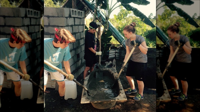 people mixing cement in bathtub