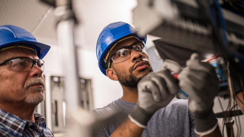 Men inspecting circuit breaker box