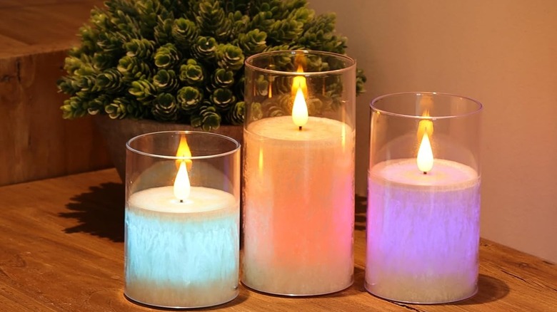 multicolored flameless candles on wood table