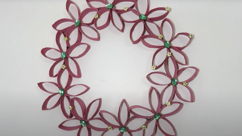 Decorative crystals glued onto a wreath make of cut up and pink-painted toilet paper rolls.