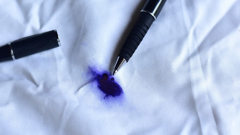 Pen leaking ink on light blue shirt