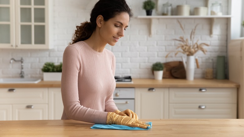 Woman polishing wooden counters