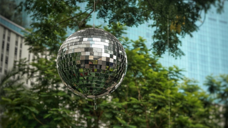 Silver disco balls hanging from tree