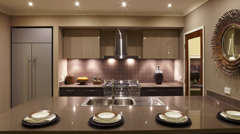 Brown modern kitchen with mauve backsplash