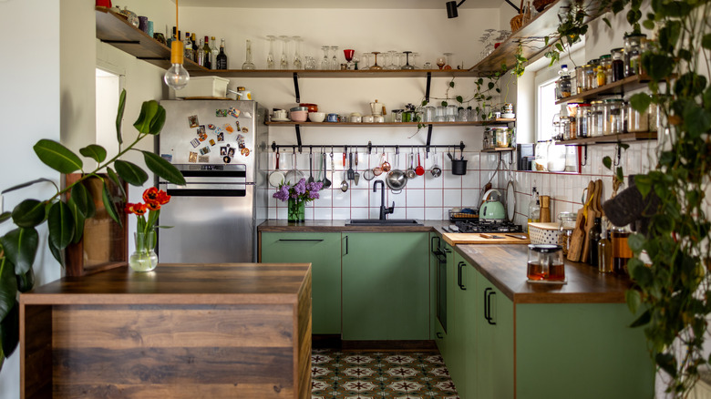 Cozy kitchen with green cabinets and wood accents