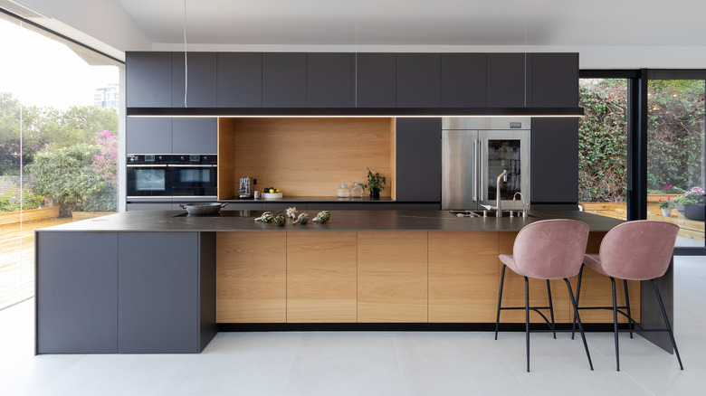 Modern gray kitchen with pink chairs