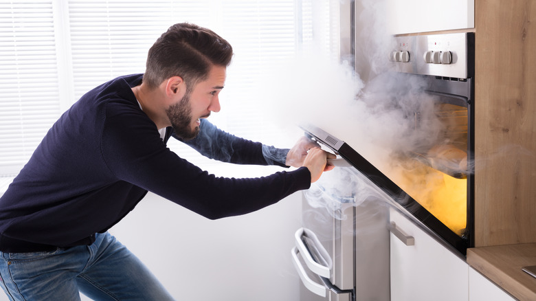 Man with a smoking oven