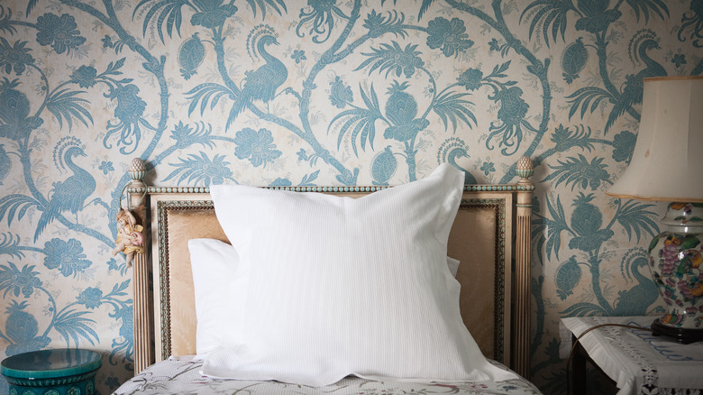 floral wallpaper behind bed