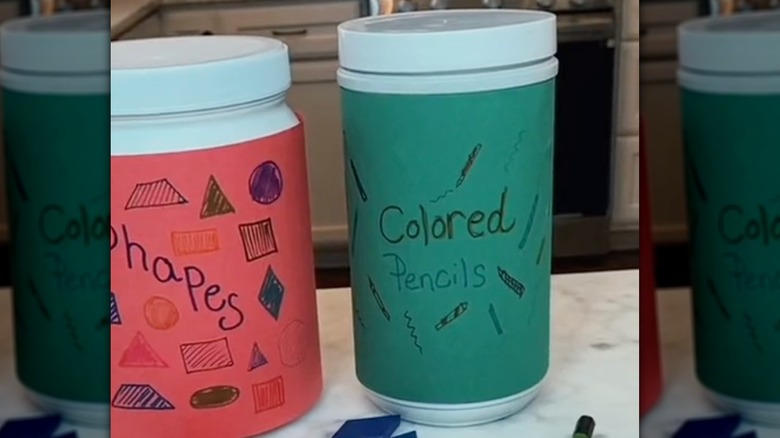 containers with pencils and shapes