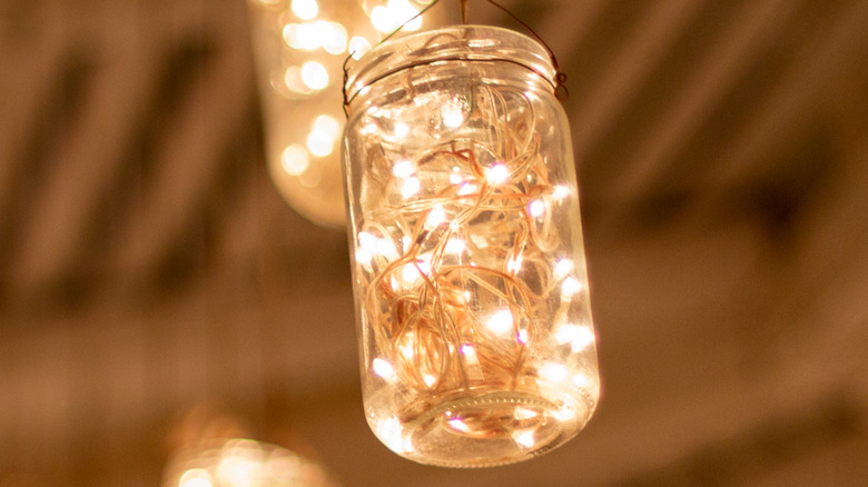 Mason jar filled with fairy lights hanging up