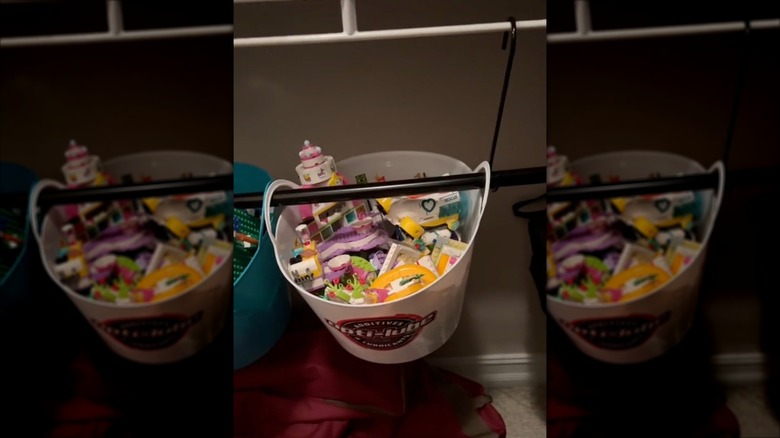 Video demonstrating how to create toy storage with a broom handle, S-hooks, and plastic bins