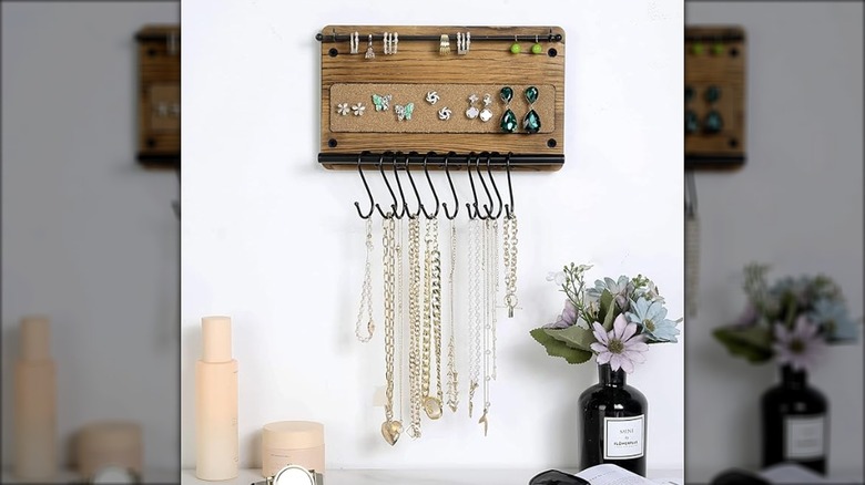 Wooden jewelry holder with a bar hanging necklaces and bracelets from it using S-hooks