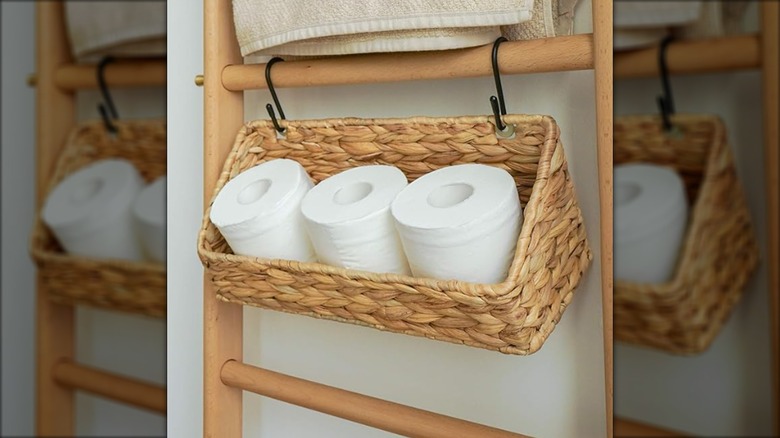 Extra toilet paper storage hanging from a storage rack from S-hooks