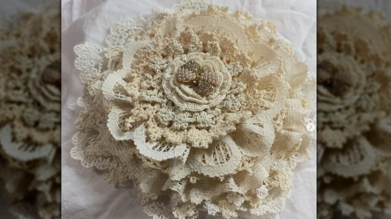 Layered flower applique made from doilies with button in center