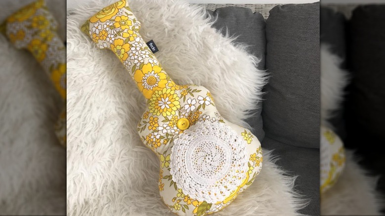 Guitar pillow in yellow floral fabric with attached doily