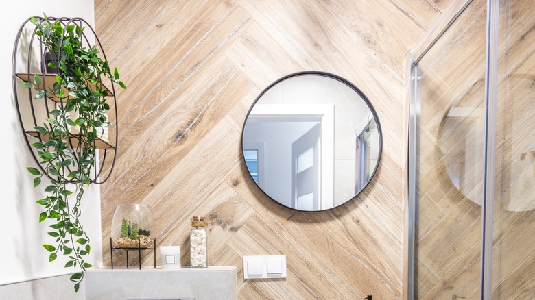 Modern small bathroom with herringbone wood accent wall